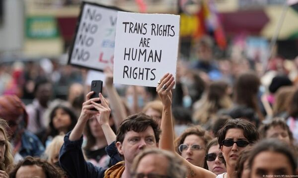 Demonstrators hold placard reading "trans rights are human rights"