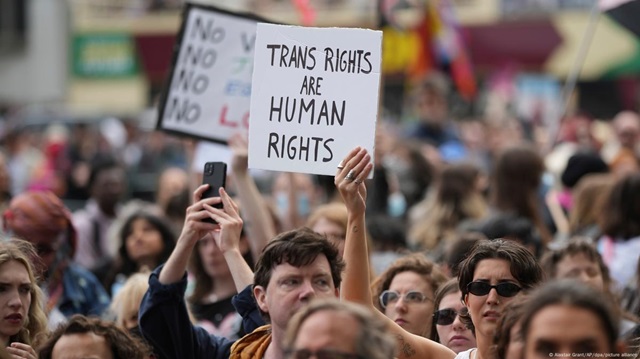 Demonstrators hold placard reading "trans rights are human rights"