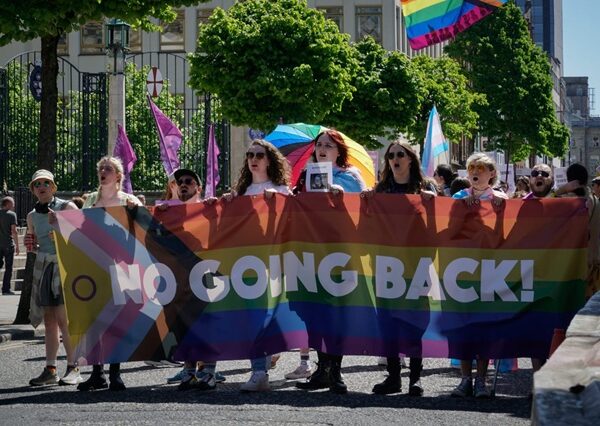 Head of trans-rights protest in Belfast with banner reading "No going back"