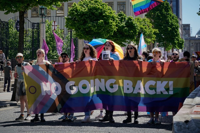 Head of trans-rights protest in Belfast with banner reading "No going back"