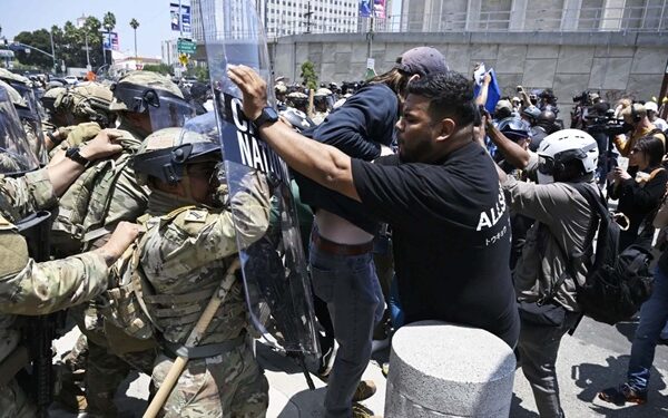 Protestors confronted by riot police in Los Angeles