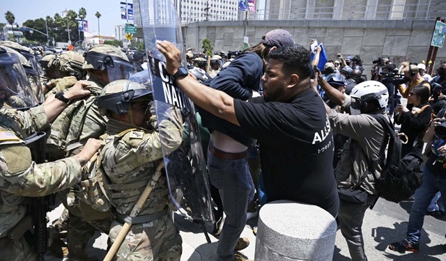 Protestors confronted by riot police in Los Angeles