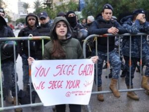 Protest outside Egyptian embassy in Beirut. The placard reads "You siege Gaza, we siege your embassy"
