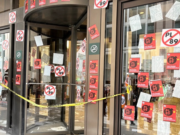 Shop-front plastered with anti-Law 89 stickers