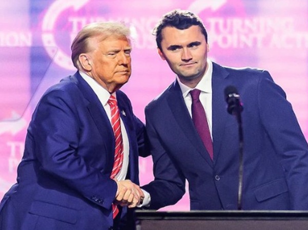 Kirk and Trump shake hands at a 
