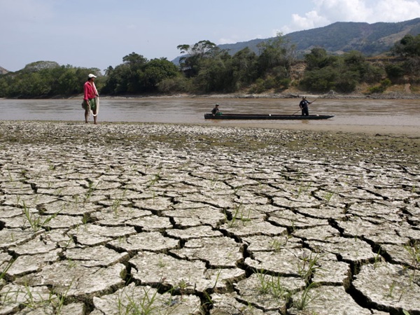 Fisherman Gabriel Barreto stands on the shore of the Magdalena river, the longest and most important river in Colombia,